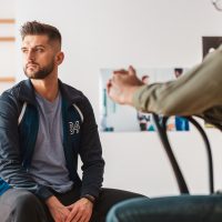 Young man with depression on a psychotherapy
